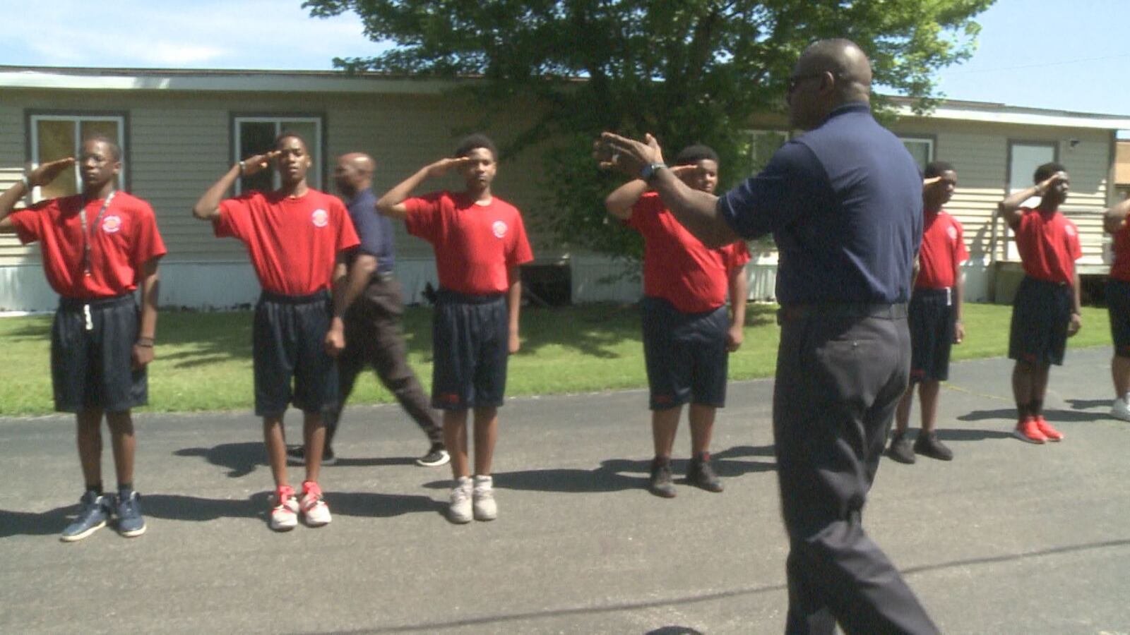 Youth leadership activity outdoors with an instructor guiding young men